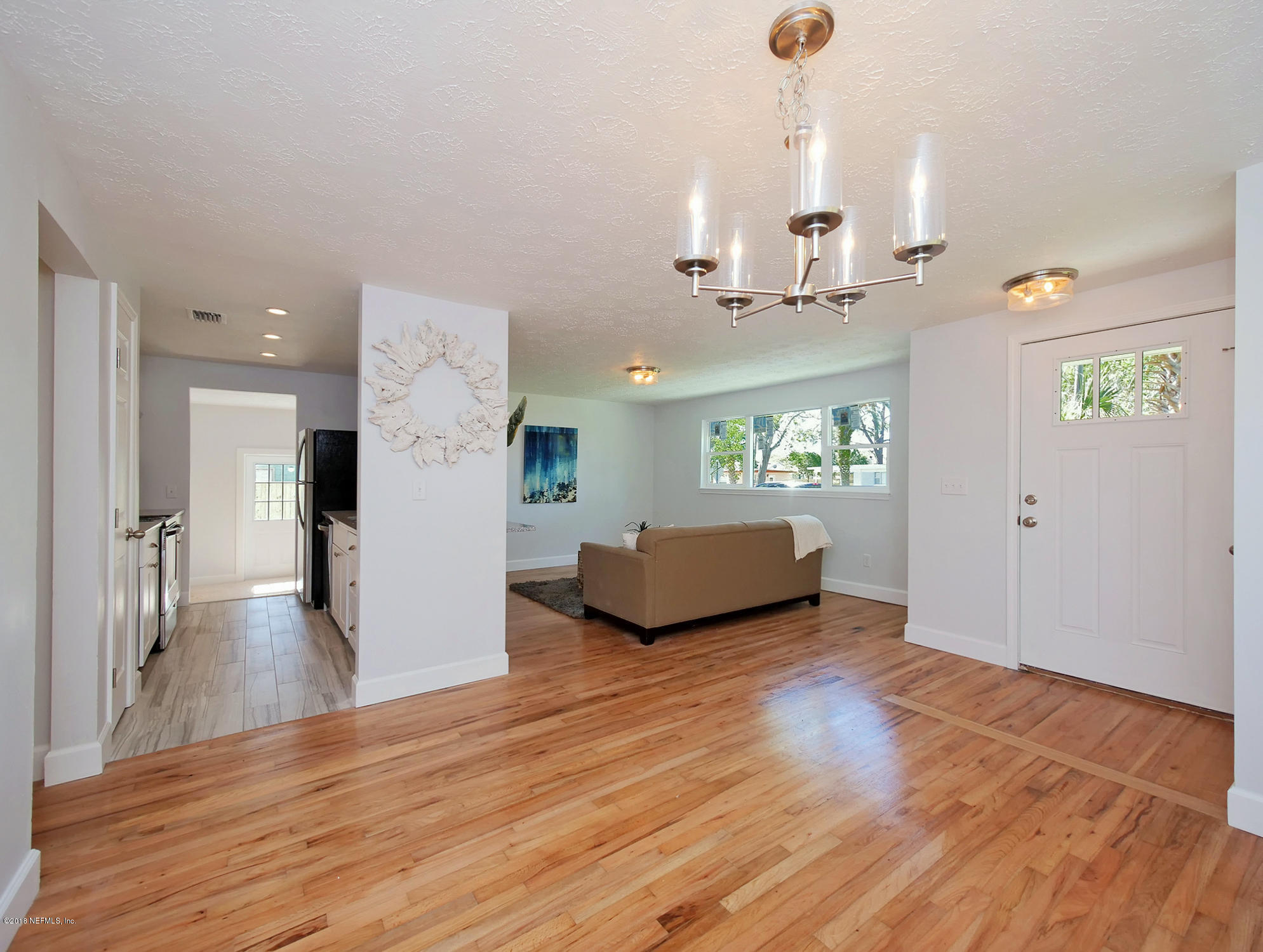 411 Skate Road Atlantic Beach, FL 32233 - Photo 26 of 26 a view of a living room and kitchen with hardwood floor