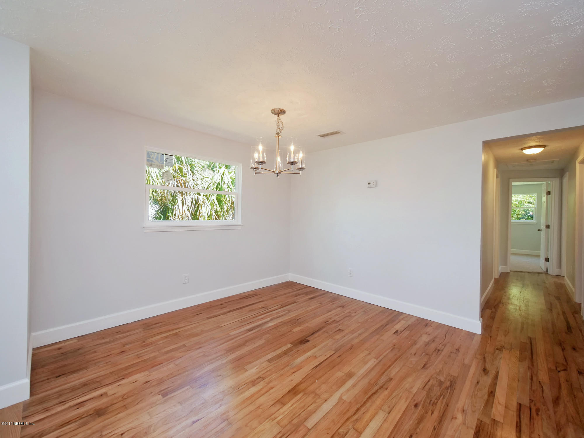 411 Skate Road Atlantic Beach, FL 32233 - Photo 5 of 26 wooden floor in an empty room with a window