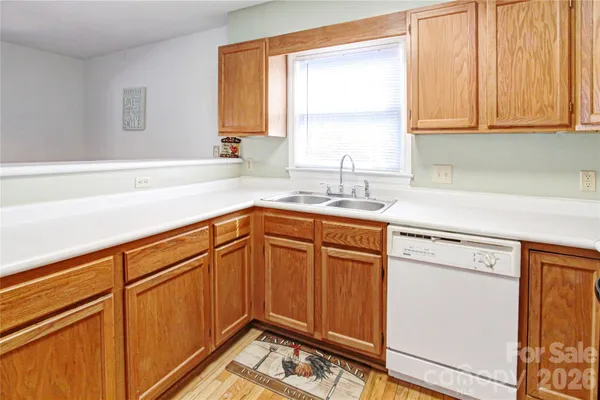 a kitchen with a white stove and refrigerator