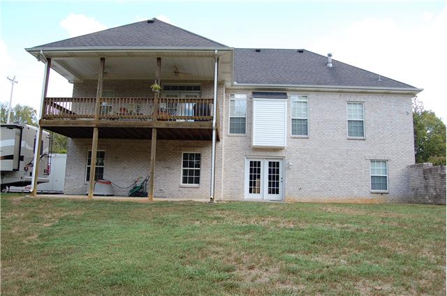 2394 Pleasant View Road Pleasant View, TN 37146 - Photo 2 of 19 View of rear of home showing covered deck, patio beneath as well as patio area off the french doors.