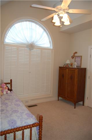 2394 Pleasant View Road Pleasant View, TN 37146 - Photo 12 of 19 Front bedroom with cathedral ceiling, and 1/2 round over window with custom window treatments