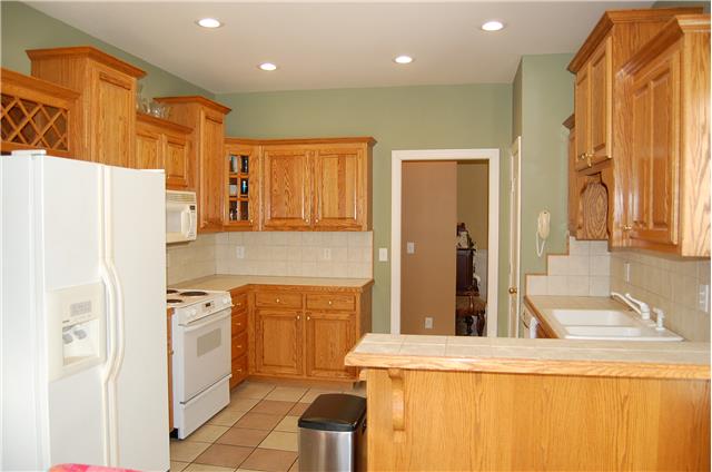 2394 Pleasant View Road Pleasant View, TN 37146 - Photo 7 of 19 Kitchen has custom oak cabinetry and tile flooring