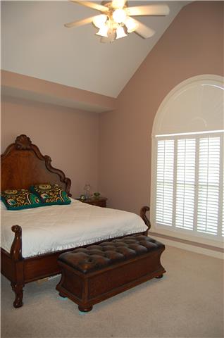 2394 Pleasant View Road Pleasant View, TN 37146 - Photo 9 of 19 Large master suite. Cathedral ceiling, ceiling fan, 1/2 round over window with custom window treatments.