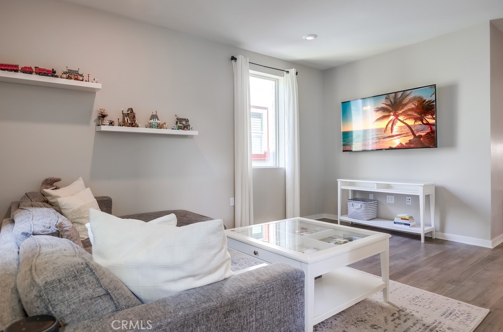 215 Bowery Irvine, CA 92612 - Photo 10 of 63 a living room with furniture and a flat screen tv