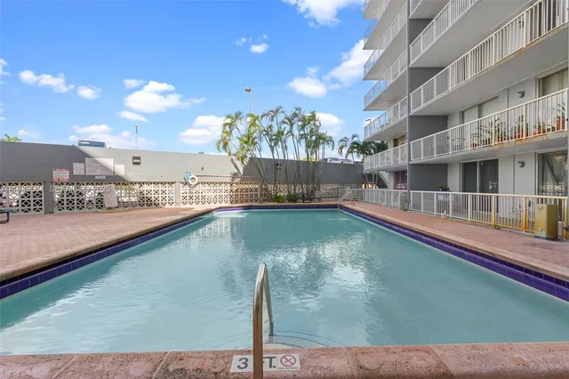 a view of a city with tall buildings and a big yard