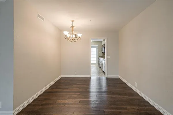 a view of livingroom with hallway and wooden floor