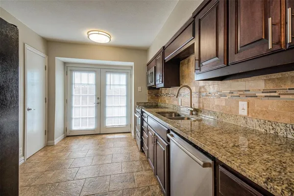 a kitchen with a sink stove and cabinets