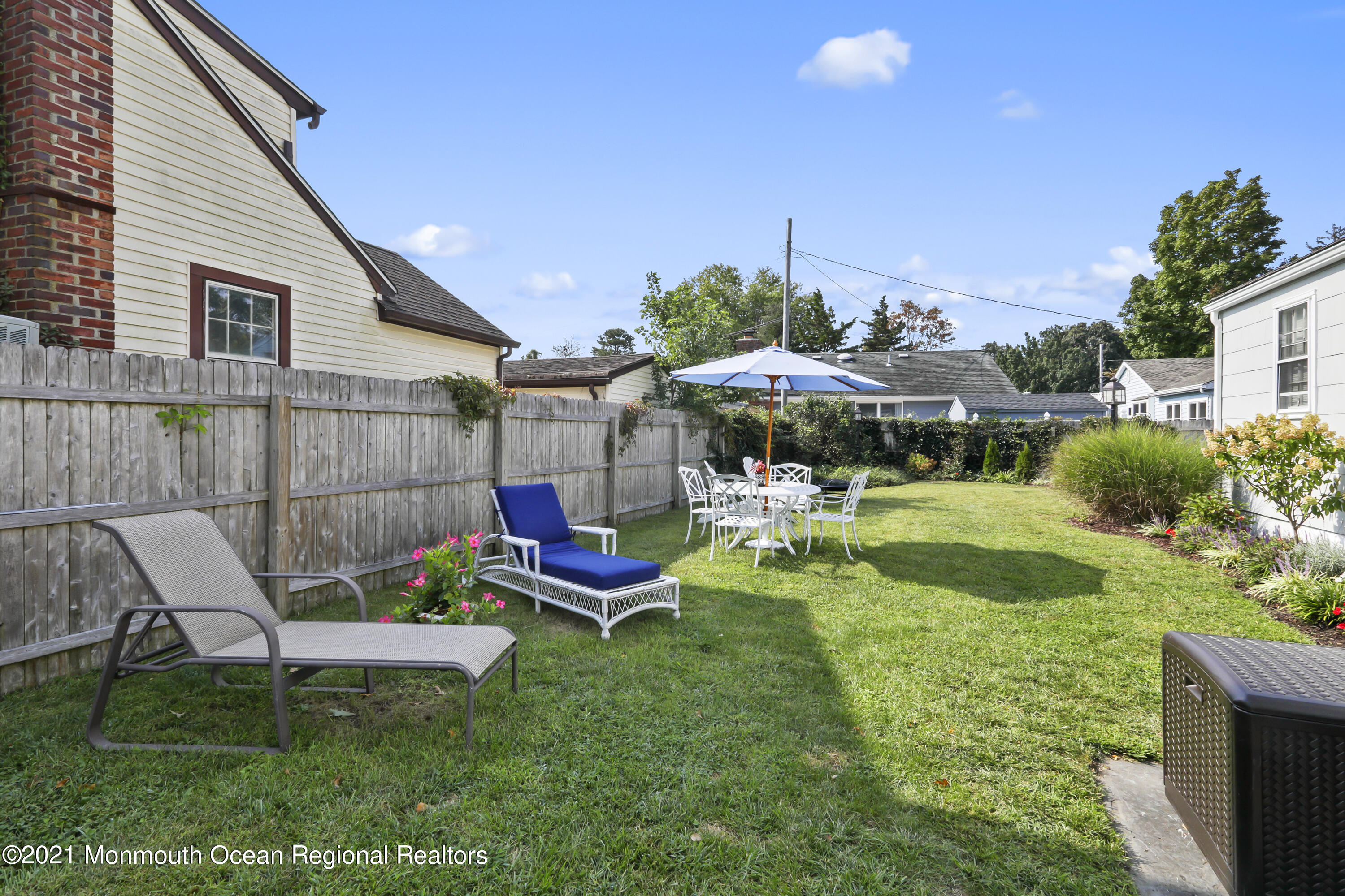 38 Hulse Landing Road Brick, NJ 08723 - Photo 7 of 38 a view of a backyard with table and chairs under an umbrella