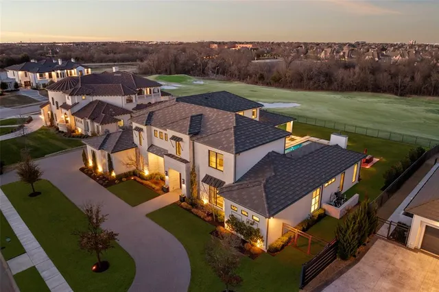 an aerial view of a house with garden space and street view