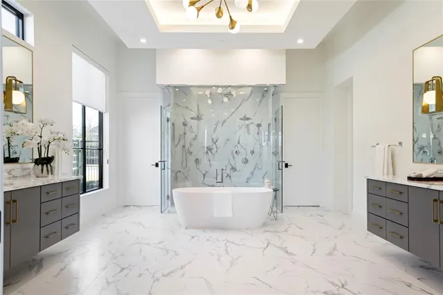 a white bath tub sitting next to a shower