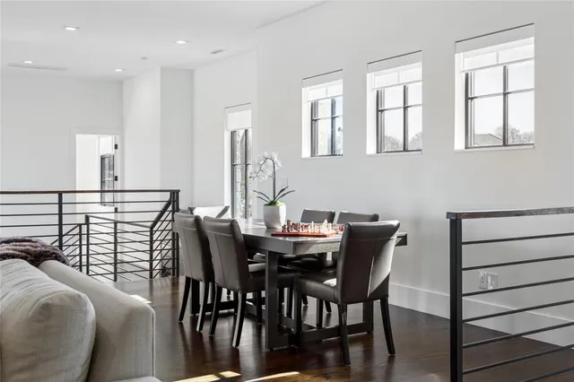 a bedroom with a bed and a dresser next to a window