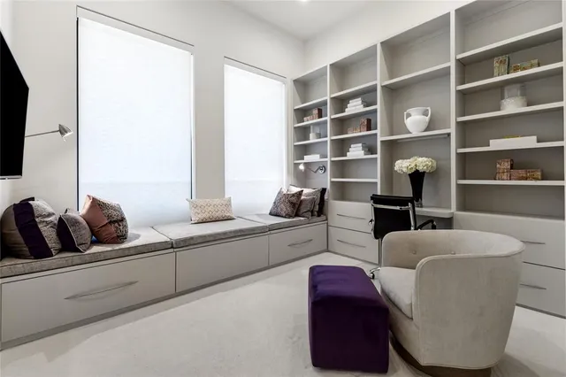 a bedroom with furniture and a flat screen tv