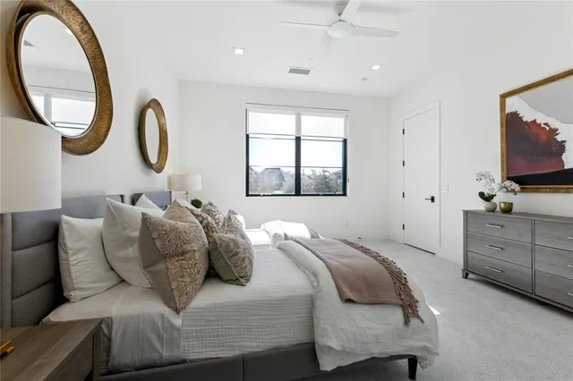 a spacious bathroom with a tub sink and mirror