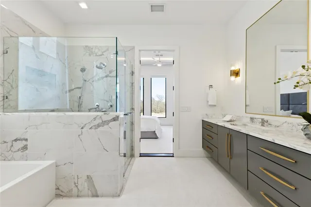 a bedroom with furniture and a large window