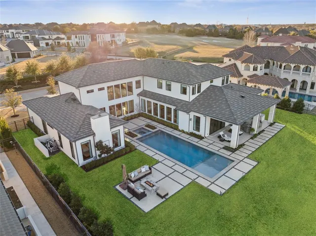 a living room with fireplace furniture and a large window