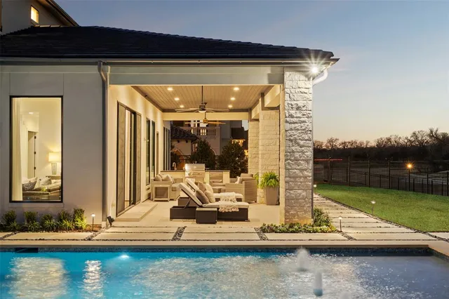 a view of swimming pool with a lounge chairs