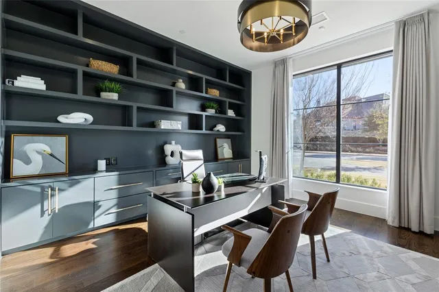 a dining room with furniture and a large window