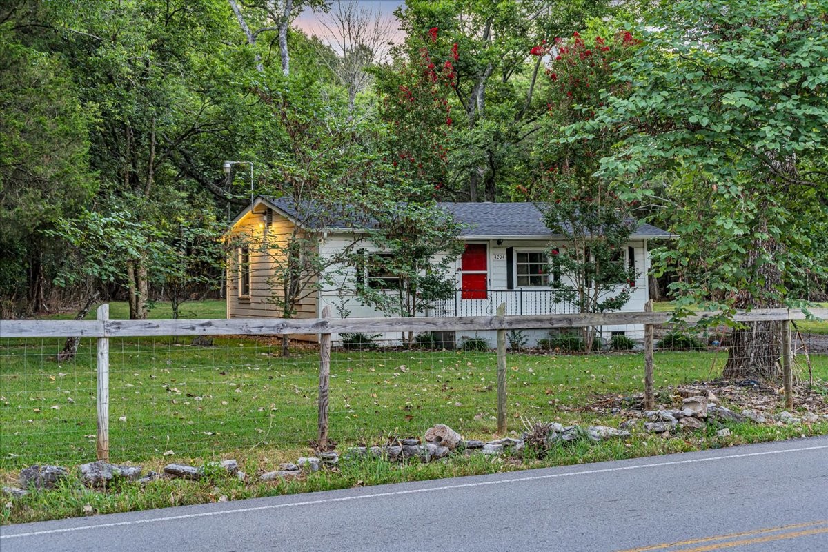 4204 Leanna Road Murfreesboro, TN 37129 - Photo 12 of 18 a front view of a house with a garden and plants