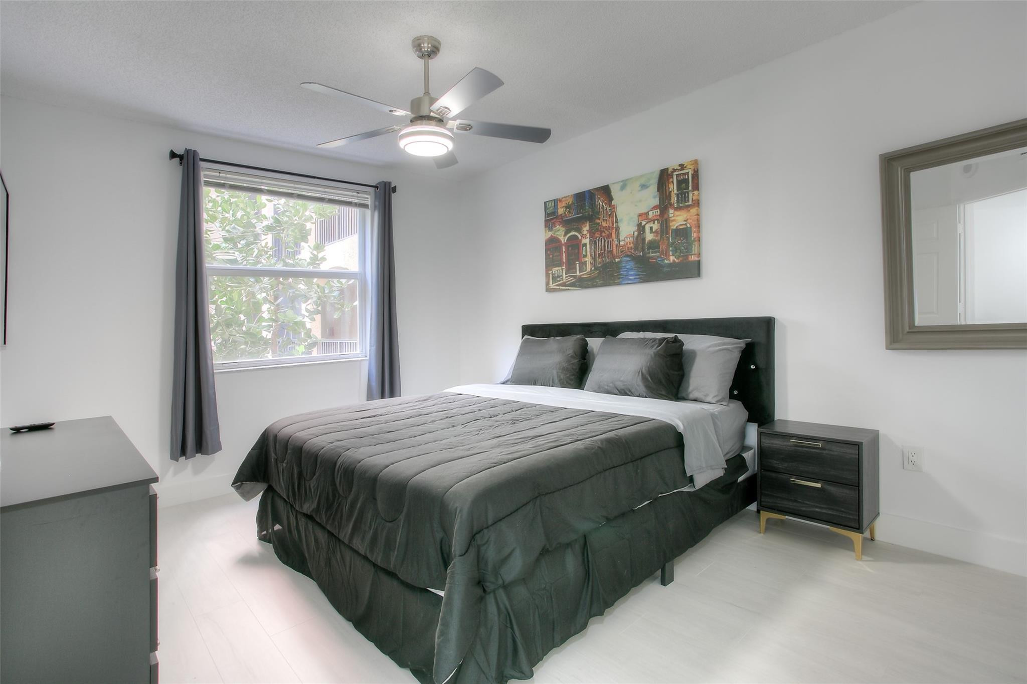 17150 North Bay Road, Unit 2218 Sunny Isles Beach, FL 33160 - Photo 5 of 15 a bedroom with a bed lamp and window
