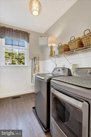 a bedroom with furniture and large windows