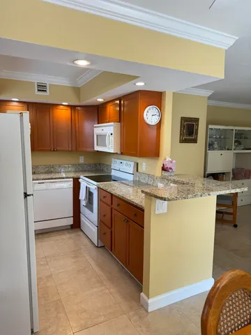 a kitchen with stainless steel appliances granite countertop a sink and a stove