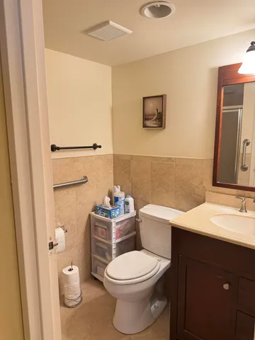 a bathroom with a toilet a sink and a mirror