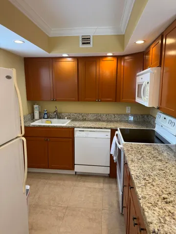 a kitchen with a sink stove and refrigerator