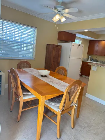 a dining room with furniture and chandelier