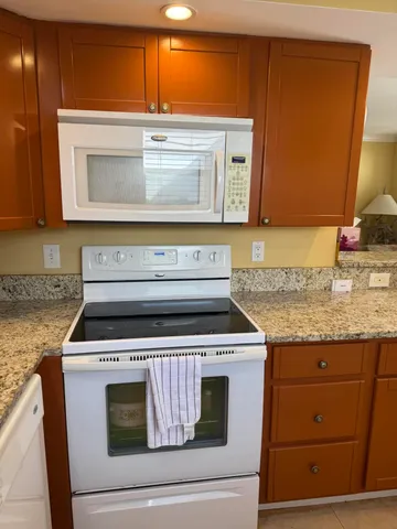 a stove top oven sitting inside of a kitchen