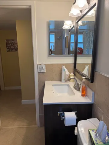 a bathroom with a sink vanity and a mirror