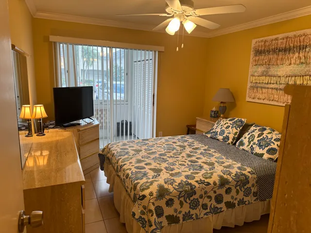 a bedroom with a bed and flat screen tv