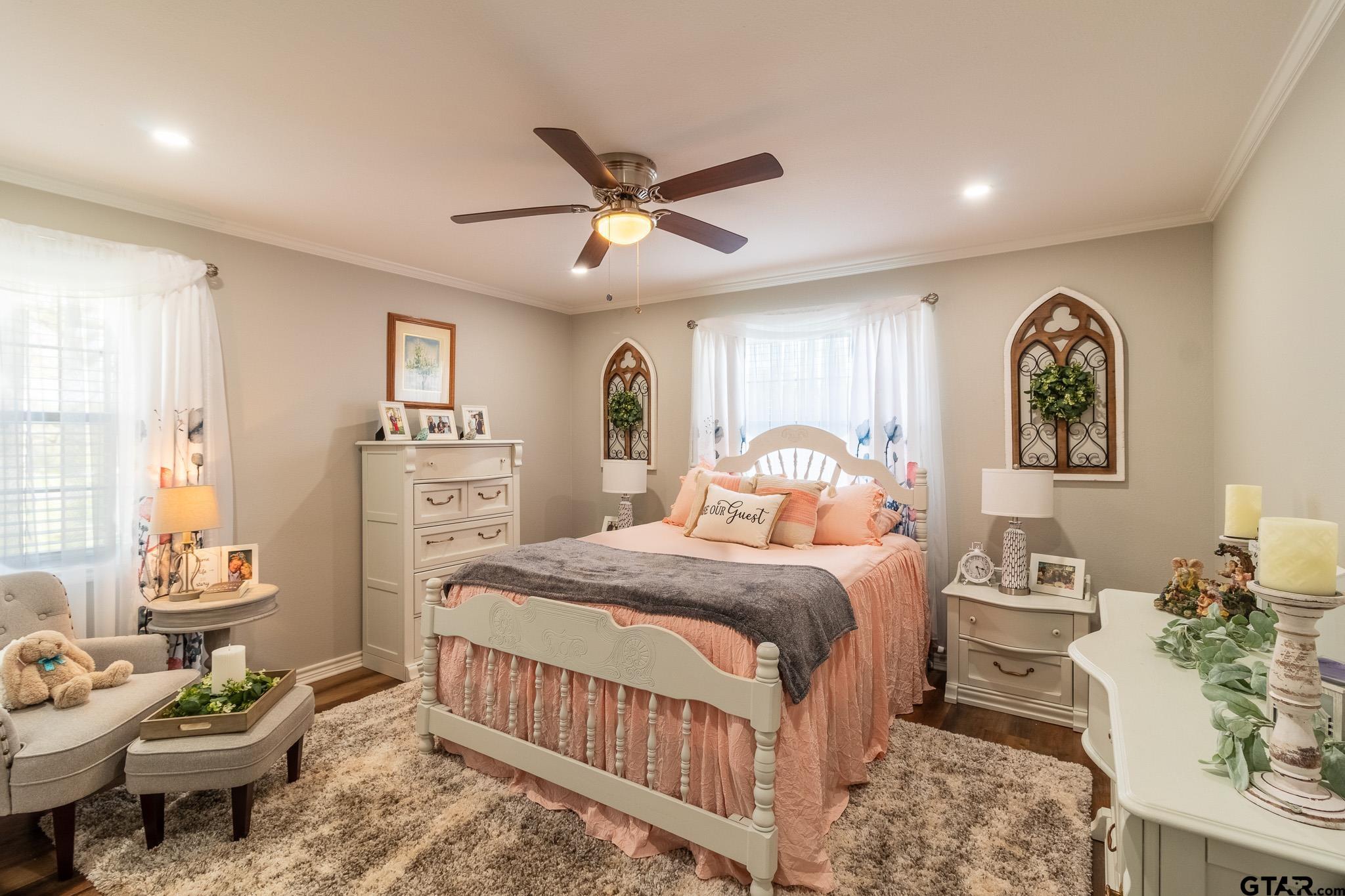 15540 State Highway 31 West Tyler, TX 75709 - Photo 16 of 37 a bedroom with a bed and a chandelier