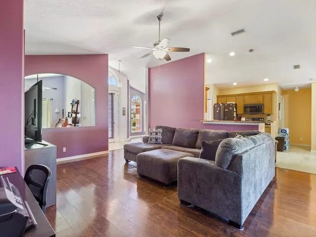 a living room with furniture and wooden floor