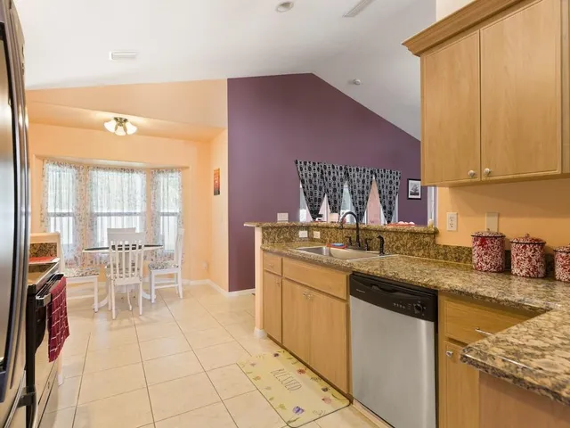 a kitchen with stainless steel appliances granite countertop a sink and cabinets