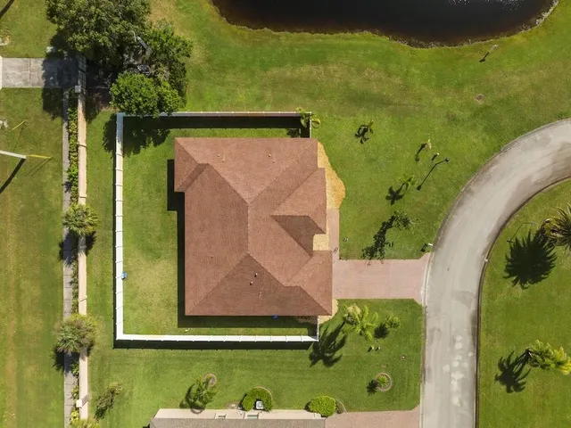 an aerial view of a house with a yard