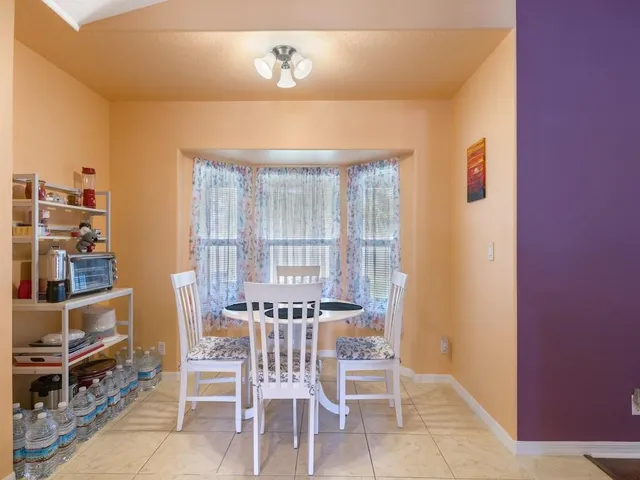 a dining room with furniture and a window