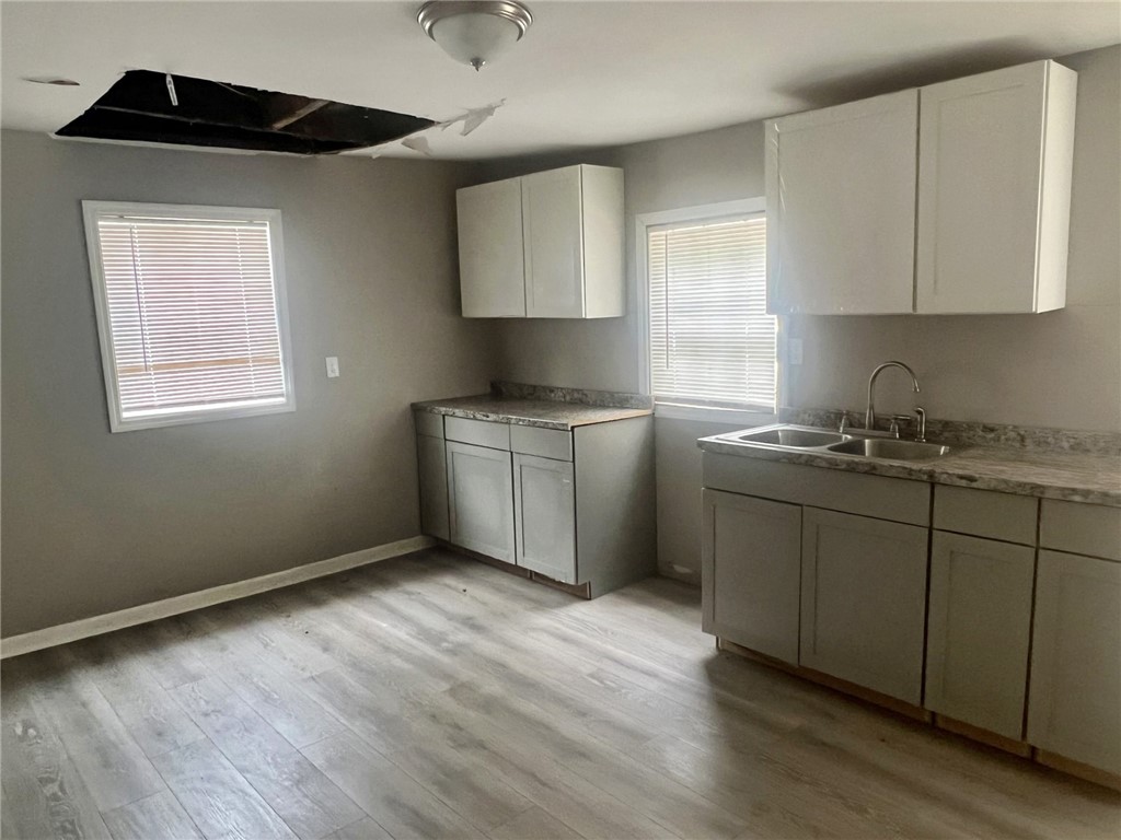 301 Hammett Street Honea Path, SC 29654 - Photo 5 of 14 This spacious kitchen offers ample cabinetry and counter space, with durable laminate flooring and natural light.