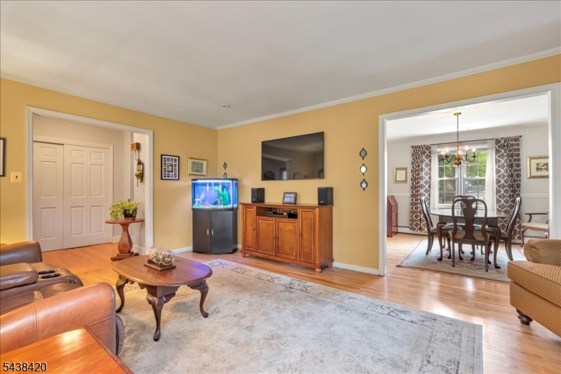 79 Main Street Califon, NJ 07830 - Photo 9 of 50 a living room with furniture and a dining table with wooden floor