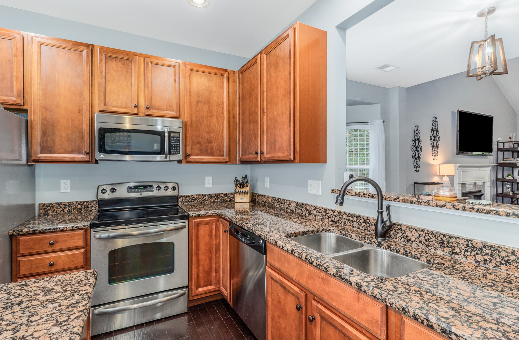 3002 Hope Circle Spring Hill, TN 37174 - Photo 13 of 25 a kitchen with stainless steel appliances granite countertop a sink stove and microwave