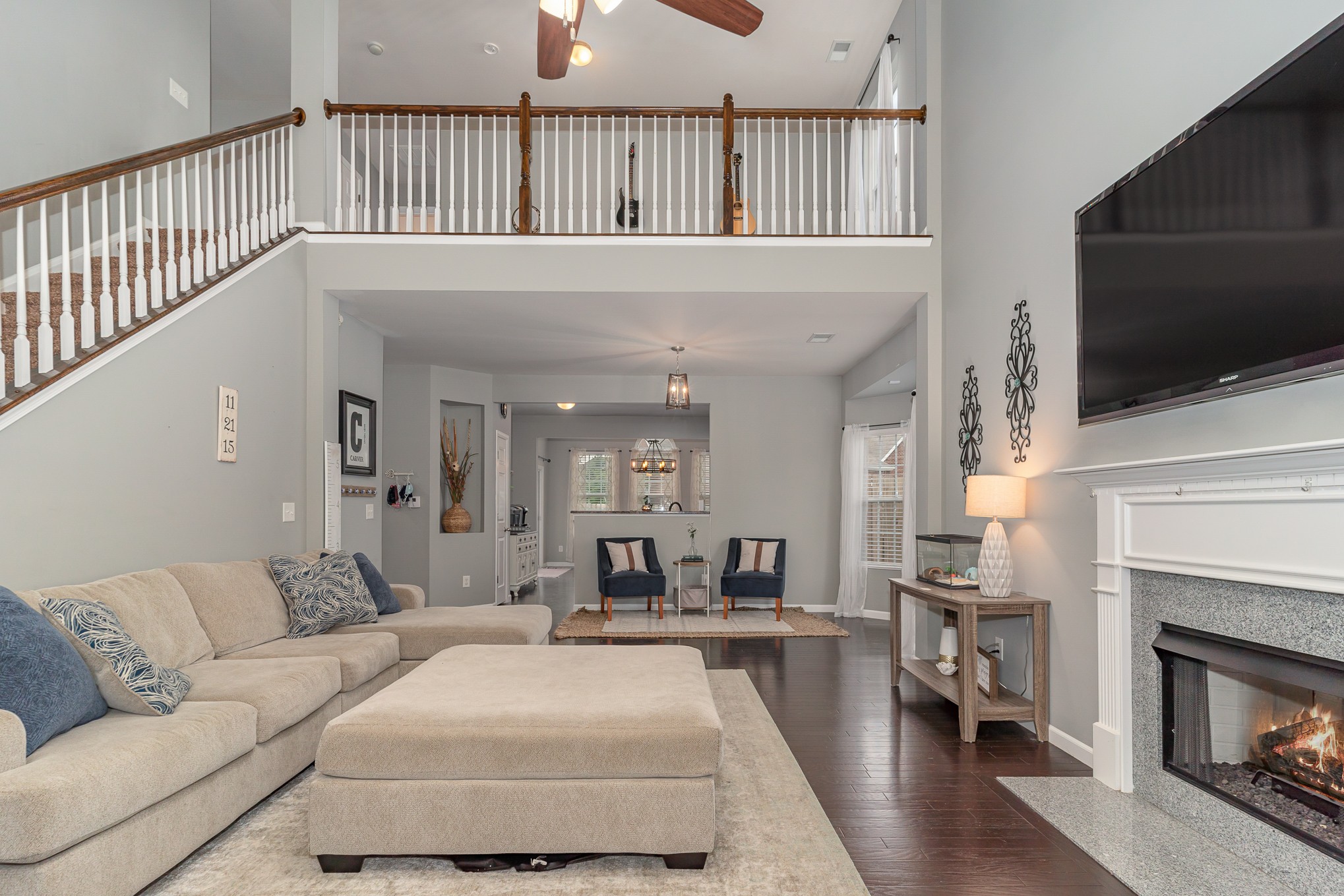 3002 Hope Circle Spring Hill, TN 37174 - Photo 4 of 25 a living room with furniture a flat screen tv and a fireplace