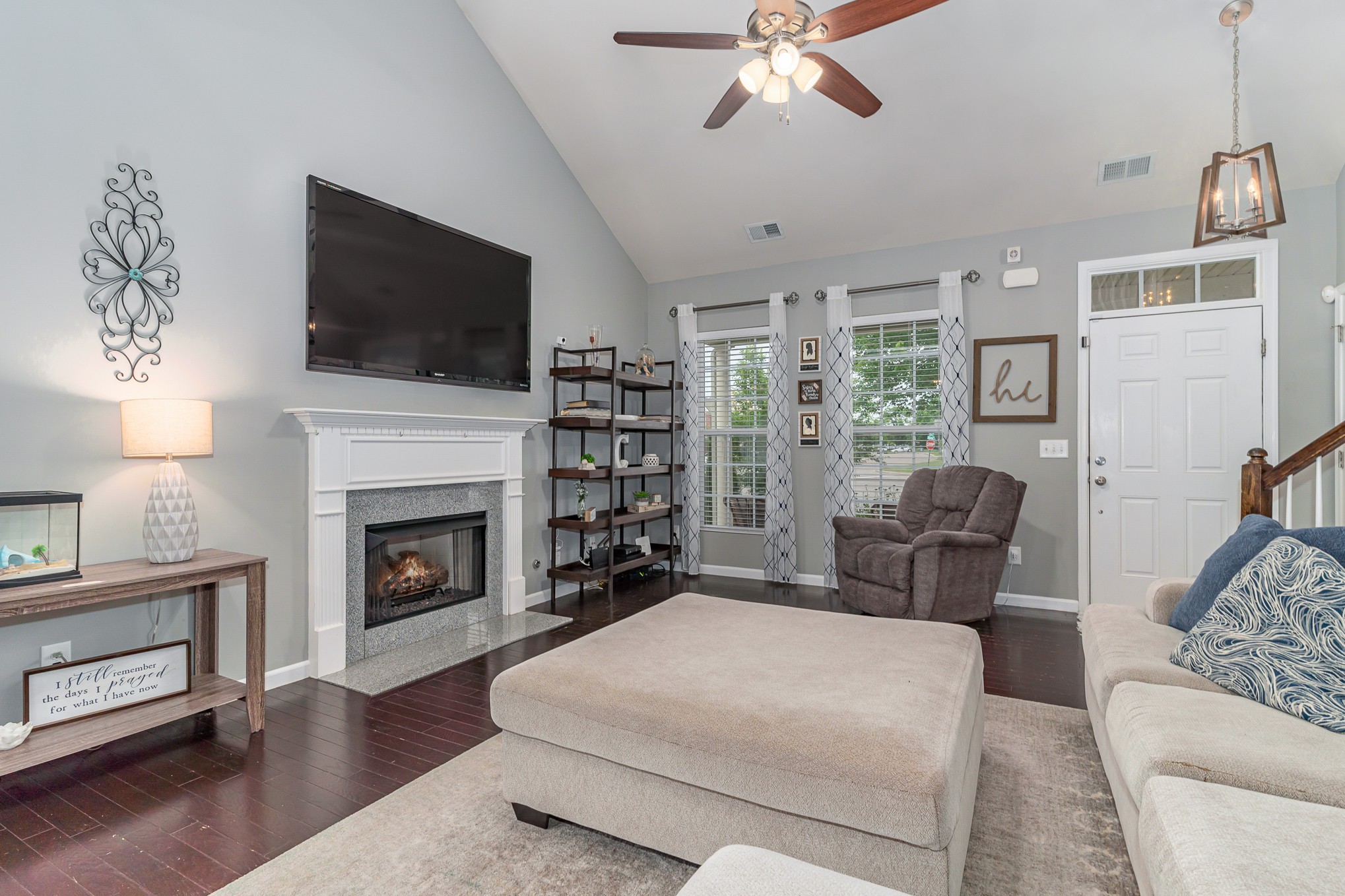 3002 Hope Circle Spring Hill, TN 37174 - Photo 5 of 25 a living room with furniture a flat screen tv and a fireplace