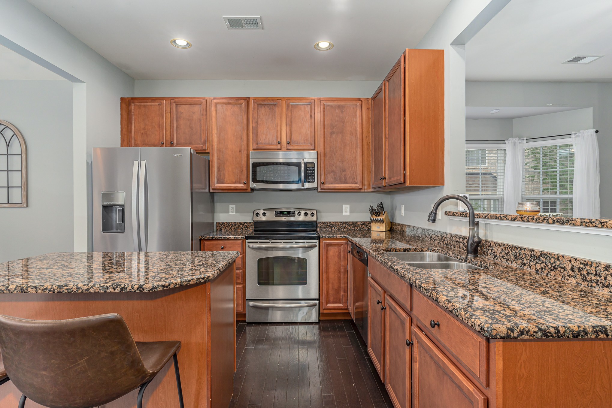3002 Hope Circle Spring Hill, TN 37174 - Photo 9 of 25 a kitchen with stainless steel appliances granite countertop a sink refrigerator and microwave