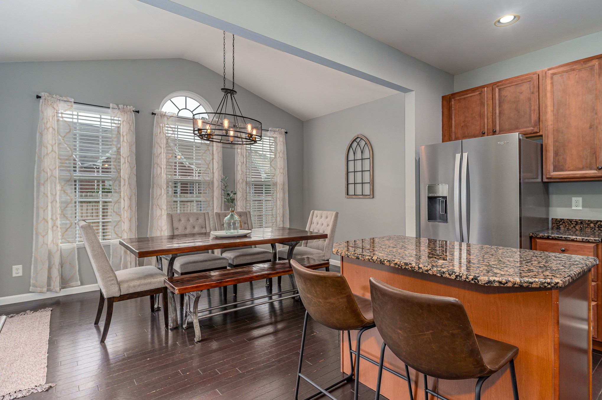 3002 Hope Circle Spring Hill, TN 37174 - Photo 10 of 25 a kitchen with stainless steel appliances granite countertop a table chairs and a refrigerator