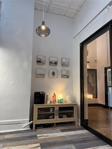 a view of a livingroom with wooden floor and a cabinet