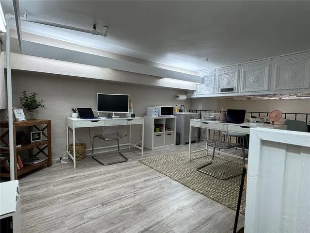 a living room with stainless steel appliances furniture a kitchen view and living room view