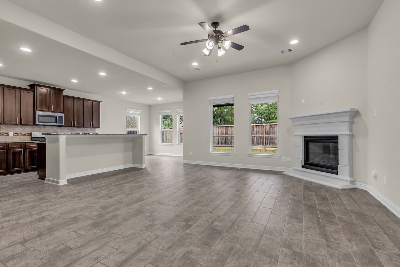 2739 Barrington Branch Drive Spring, TX 77373 - Photo 10 of 41 Living room with fireplace and open to kitchen