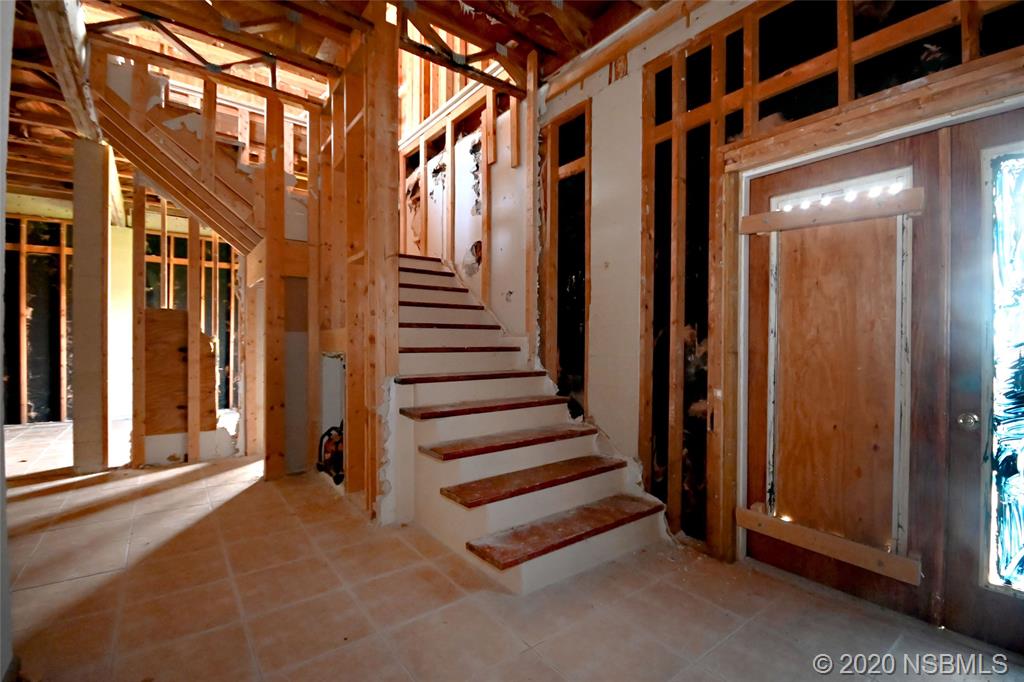 6829 Turtlemound Road New Smyrna Beach, FL 32169 - Photo 14 of 38 a view of a porch with wooden floor and stairs