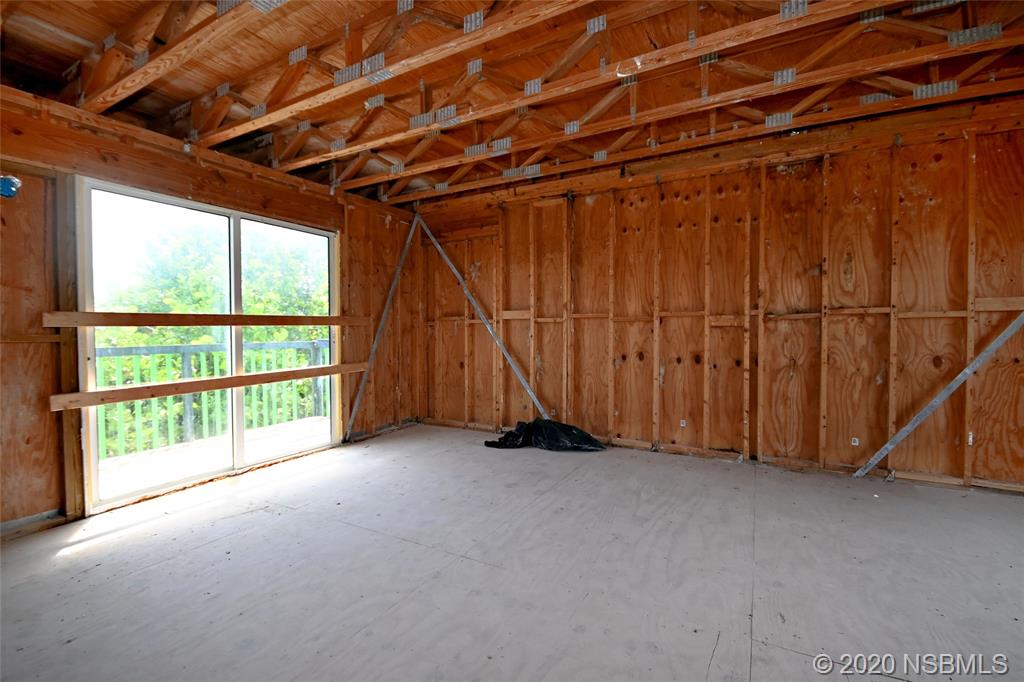6829 Turtlemound Road New Smyrna Beach, FL 32169 - Photo 15 of 38 a view of an empty room with a garage