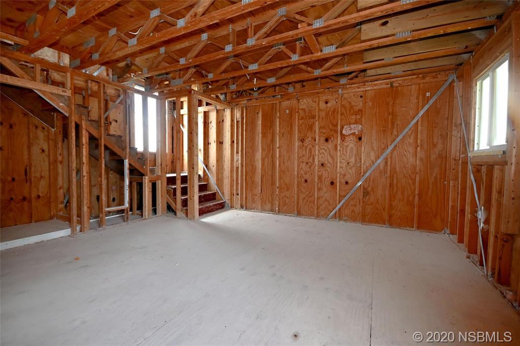 6829 Turtlemound Road New Smyrna Beach, FL 32169 - Photo 21 of 38 a view of an empty room with stairs