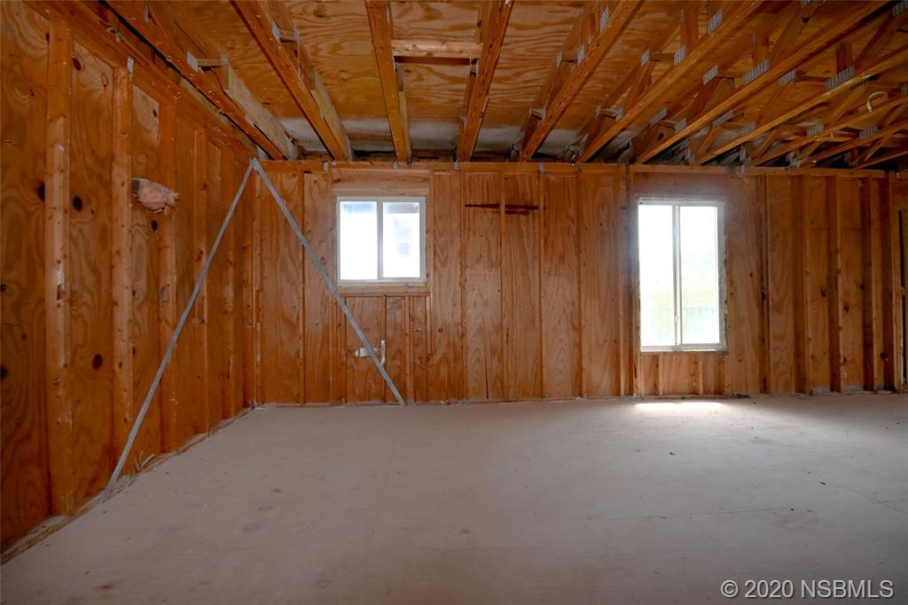 6829 Turtlemound Road New Smyrna Beach, FL 32169 - Photo 22 of 38 a view of empty room with windows